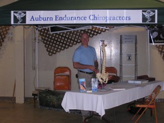 Photo of Dr. SMith at a volunteer booth at a local marathon event